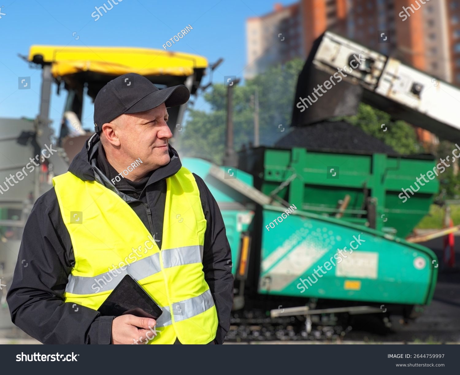 stock photo man foreman of road construction company guy near asphalt paving equipment contractor of road 2644759997