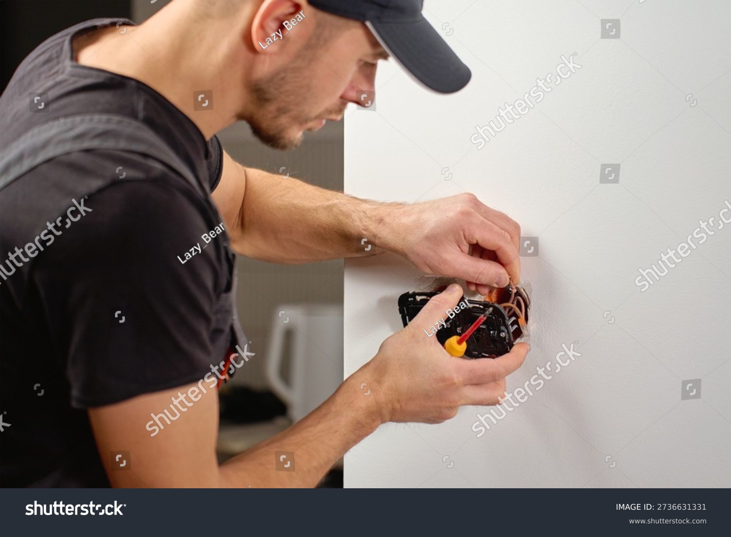 stock photo man installing electrical wall switch and connecting wires inside white wall using screwdriver 2736631331